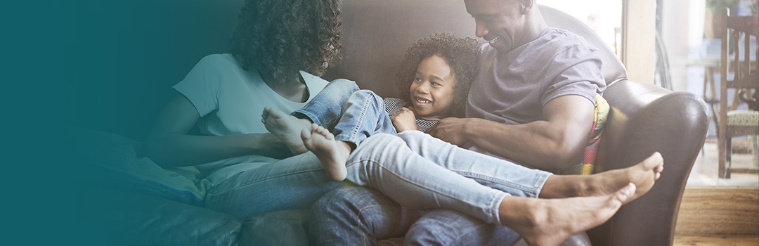 family relaxing on sofa
