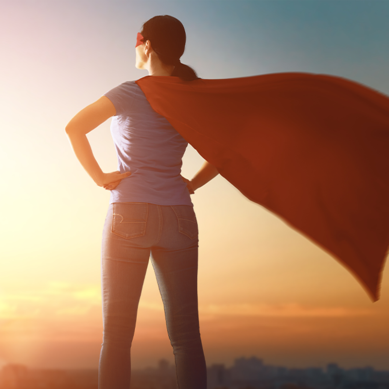 A woman wearing a super hero cape