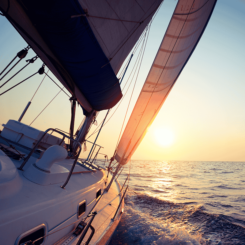 A boat sailing at sunset