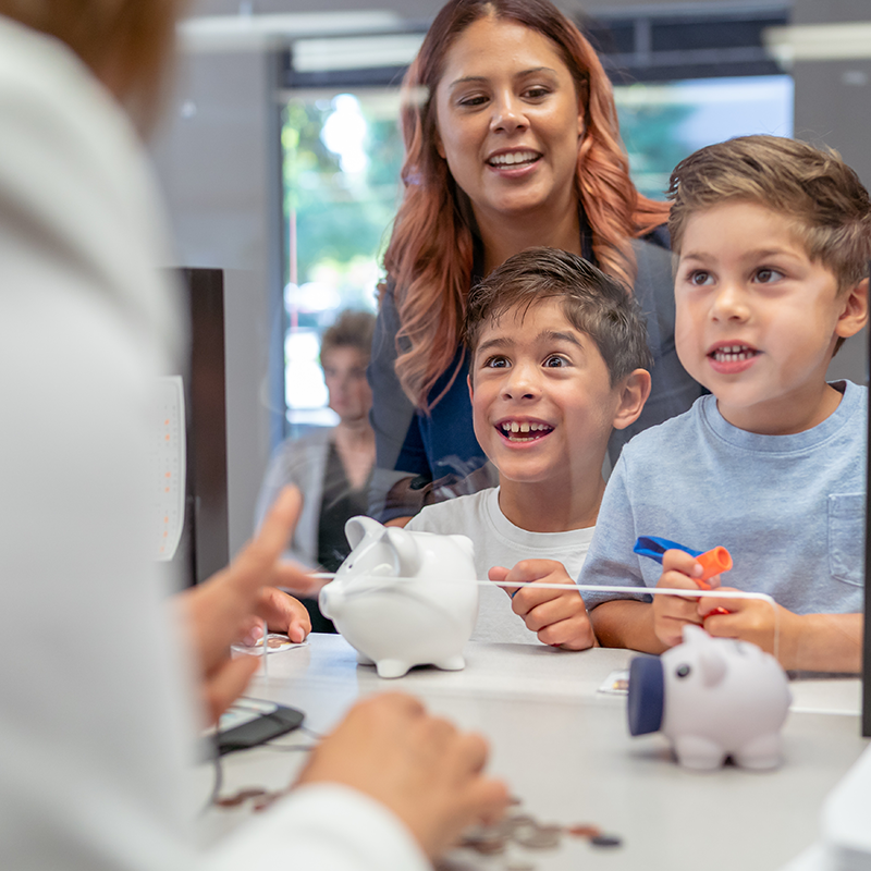 A mother and two kids talking with a Vantage employee