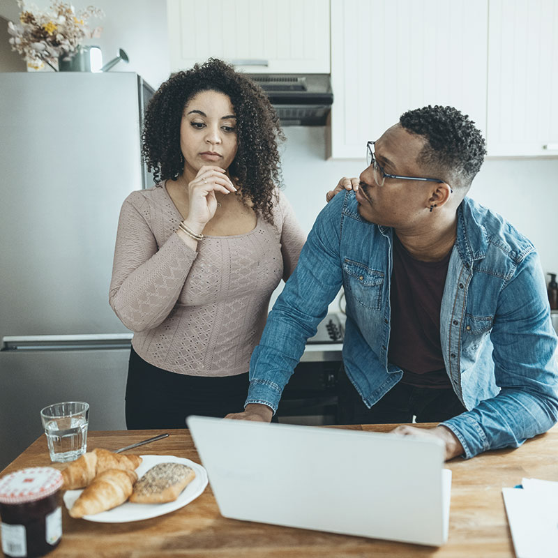 A couple looking at their laptop