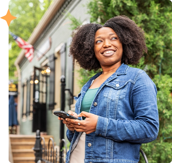 Woman looking at phone outside restaurant