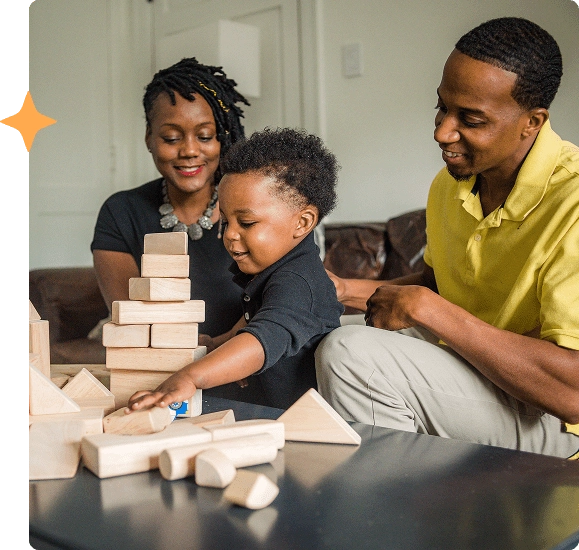 A family playing building blocks with their son