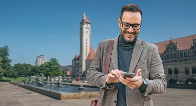 Business man looking at phone is St. Louis City